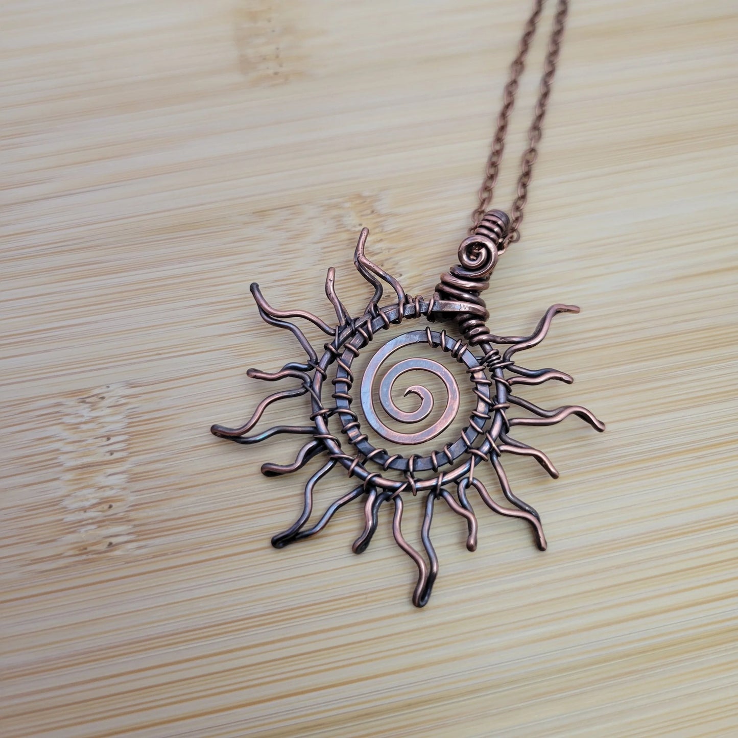 Handcrafted Copper Sun Pendant Necklace — reverse view